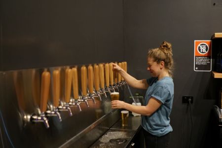 Harriet McCready pouring a beer at Mountain Culture. 